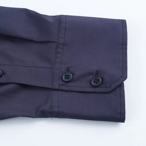 Detailed close-up of dark blue shirt cuffs featuring two matching buttons and fine stitching