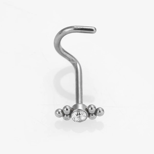 Macro view of S-shape stainless steel nose stud with zircon and silver beads
