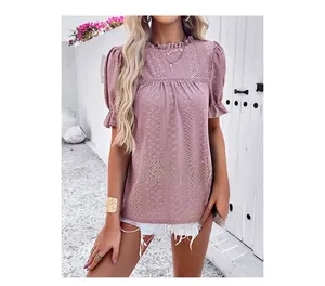 Detail of pink hollow lace top featuring ruffled high collar and puff short sleeves