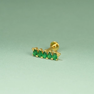 Detail of gold cartilage stud with five sparkling marquise-cut green zircon stones