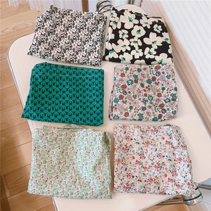 Detailed overhead view of six assorted floral pattern fabric swatches in a grid layout
