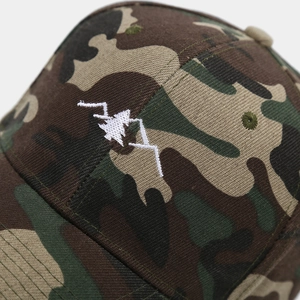 Detailed close-up of mountain embroidery on a camouflage twill baseball cap
