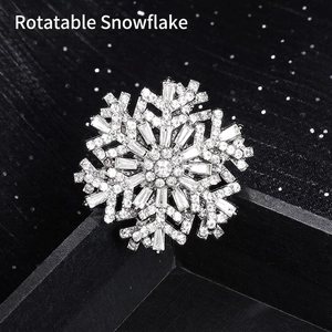 Elegant rotating silver snowflake brooch with sparkling cubic zirconia on black box