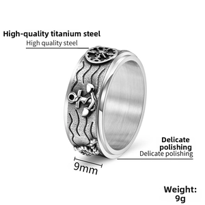 Detailed macro view of 9mm stainless steel rotating ring with anchor and compass motifs