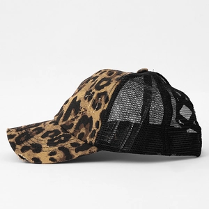 Detailed side view of leopard print baseball cap with distressed brim and black mesh