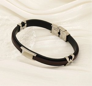 Detail of silver stainless steel buckle on double-layer black and brown leather bracelet