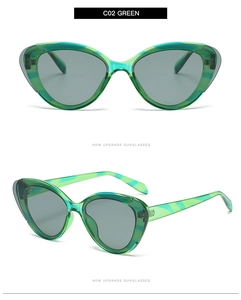 Close-up of green cat eye sunglasses with translucent frames and grey tinted lenses