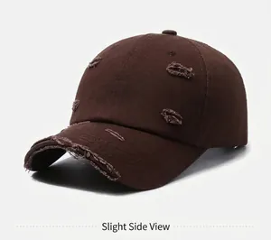 Detailed side view of dark brown distressed baseball cap with ripped fabric edges