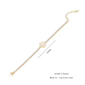 Detailed view of a gold-tone stainless steel bracelet with a shell flower and crystals