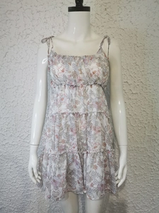 Detailed view of spaghetti straps and layered ruffle hem on floral print dress
