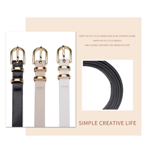 Detailed view of slim faux leather belts in black beige and white with golden D-shaped buckles