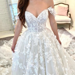 Elegant off-shoulder ball gown wedding dress with delicate lace floral appliques