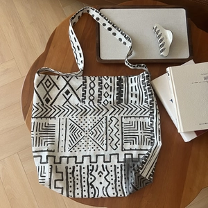 Detail view of large bohemian cotton linen tote bag with black geometric tribal prints