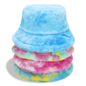 Close-up of fluffy faux rabbit fur bucket hats in solid blue and vibrant tie-dye colors