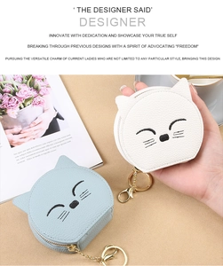 Close-up of cat-shaped coin purse with embroidery, metal keychain and zipper detail