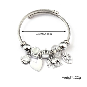 Detail view of steel wire bracelet with shell and elephant charms, 5.5cm inner diameter