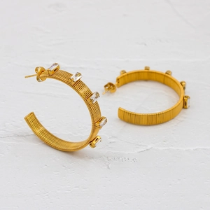 Golden C-shaped hoop earrings with spring texture and rectangular cubic zirconia stones