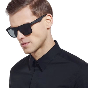 Close-up of classic black men's square sunglasses worn on a model against white background