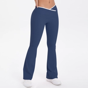 Detail of high-waisted flared yoga pants with crossover V-waist and white contrast trim
