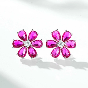 Detailed view of silver daisy studs with rose-red petals and center white crystals