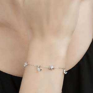 Elegant S925 sterling silver star and moon bracelet with zircon stones on a model's wrist