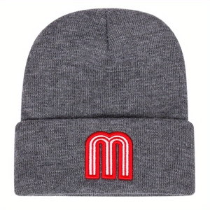 Grey knit beanie featuring white embroidered letter M with red outline on a folded cuff