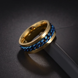 Macro shot of gold stainless steel ring with a blue chain inlay for men