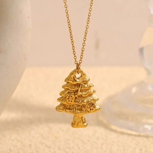 Macro shot of 18K gold plated Christmas tree pendant on a stainless steel necklace