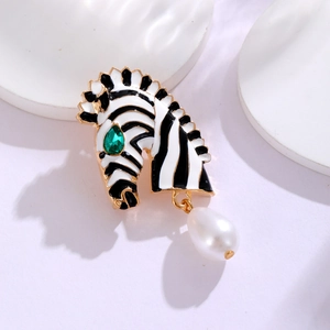 Close-up of zebra head brooch with black white enamel, green rhinestone eye and pearl drop