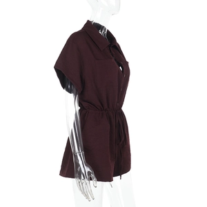 Detail view of burgundy romper with shirt collar and drawstring waist on mannequin