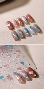 Detail of 3D metallic nail stickers featuring golden heart and butterfly designs