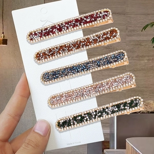 Five-piece minimalist rhinestone bobby pins set in assorted colors on gold alloy base