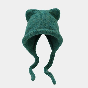 Winter knitted cat ear beanie with earflaps in dark green color for outdoor warmth