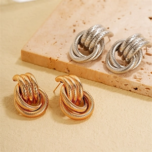 Minimalist twisted rope knot stud earrings in gold and silver finishes on stone
