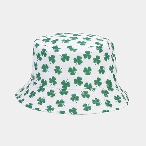 Close-up of white canvas bucket hat featuring green clover patterns and neat stitching