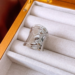 Close-up of silver wide open ring with irregular hammered texture in a jewelry box