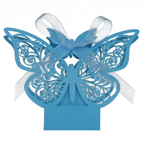 Detail of blue laser-cut butterfly gift box with elegant matching ribbon bow