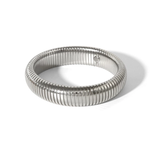 Detailed view of silver stainless steel cuff bracelet with a vertical ribbed surface texture