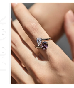 Detail of silver double stone ring with purple oval and white teardrop zircons