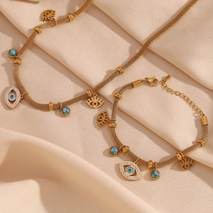 Detailed macro of 18K gold plated mesh chain with turquoise evil eye pendant on silk