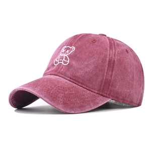 Close-up of embroidered white bear design on vintage washed cotton baseball cap