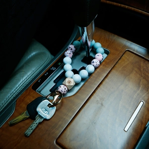 Silicone beaded wristlet keychain with pink beads and butterfly engraved wood charm
