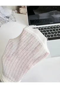 Detail showing the elastic ribbed texture and sheer white cotton fabric of the socks