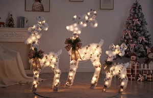 Three-piece glowing white flocked reindeer set with warm LED lights and bows
