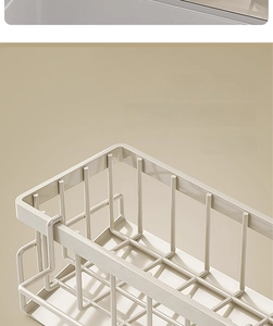 Detail of cream-colored kitchen sink organizer featuring rust-resistant painted metal mesh