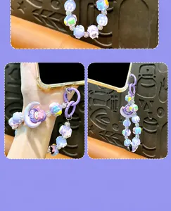 Detailed close-up of a purple beaded phone strap with moon and hand-painted charms.