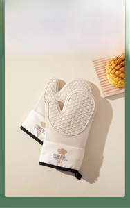 Close-up of cream silicone oven mitts with diamond non-slip texture and hanging loops
