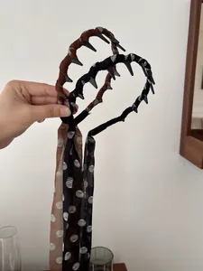 Close-up of retro brown and black polka dot ribbon headbands with clip hair accessories