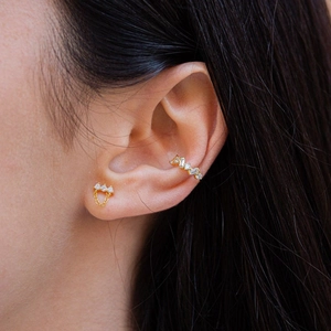 Elegant gold S925 silver needle drop earrings with three zircons and chain on model ear