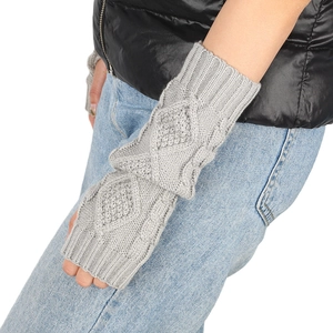 Detail of grey cable-knit arm warmers with intricate twist patterns and fingerless design